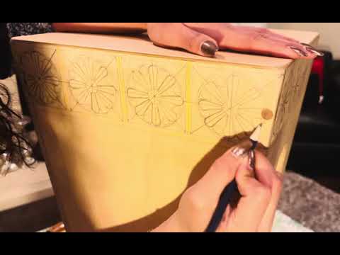 Victoria Rosas drawing design on a cajón.